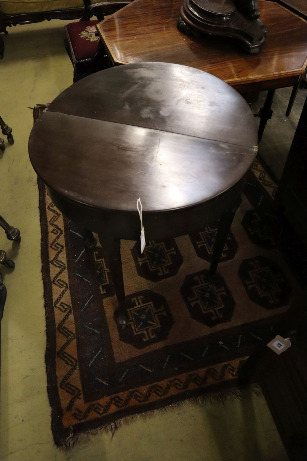A George III D shaped mahogany folding tea table, width 68cm depth 33cm height 73cm